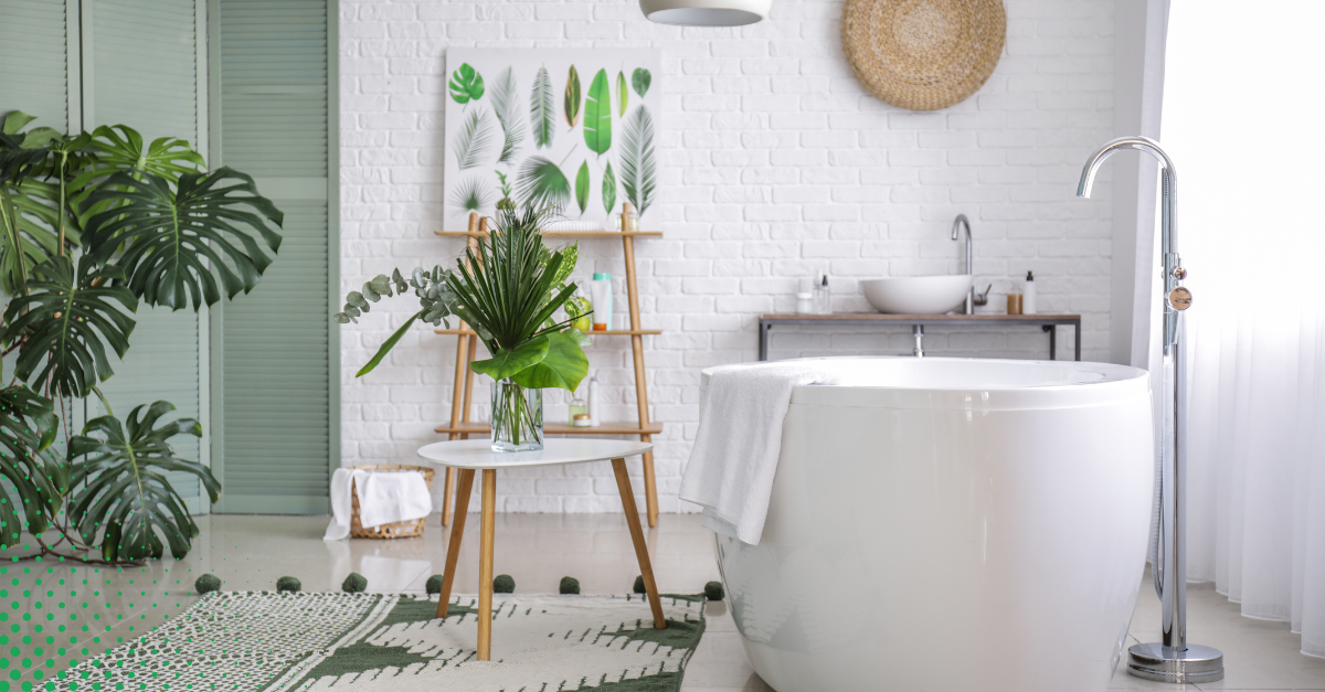 Modern bathroom design featuring a freestanding white soaking tub, vibrant greenery, a bohemian rug, and minimalist decor elements