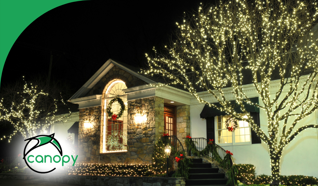 A beautifully decorated home illuminated with twinkling holiday lights and festive wreaths at night.