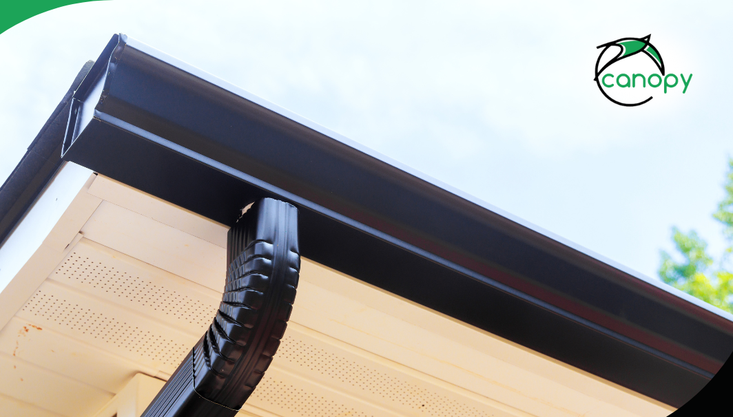 Newly installed gutter with downspout.