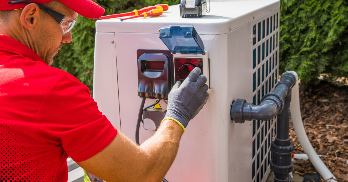 Technician checking outdoor HVAC system.