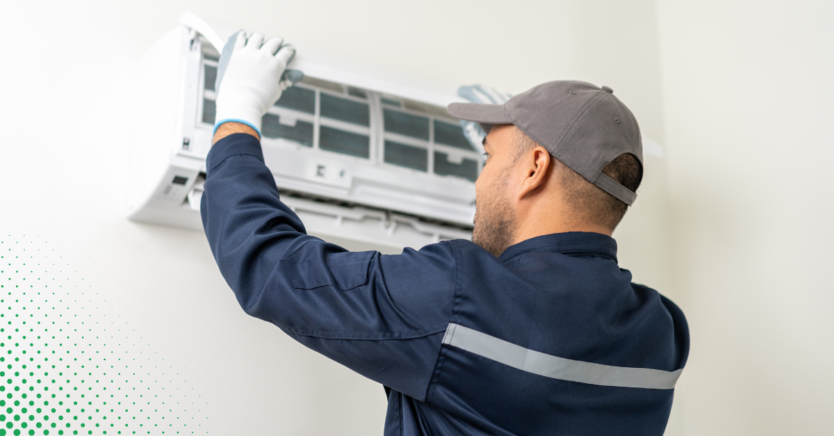 Technician performing air conditioner maintenance