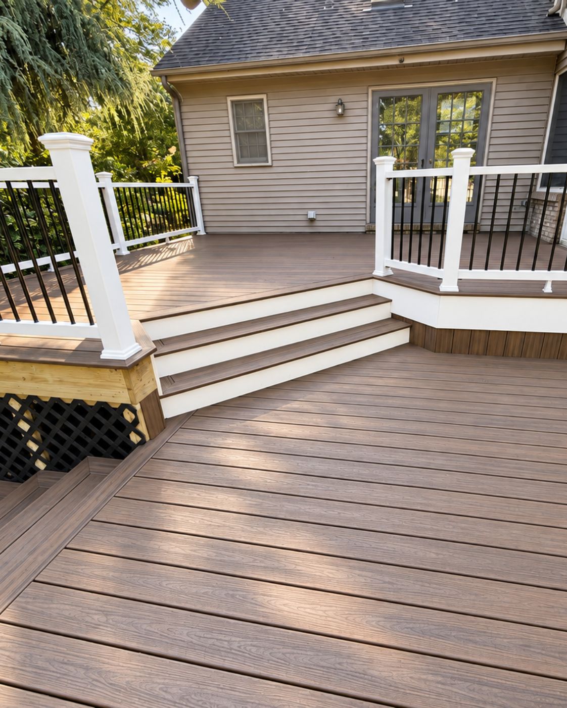 New composite railing with wrapped posts on renovated multi-level deck by Canopy Building Services