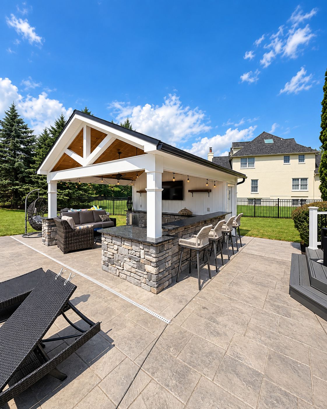 Custom outdoor bar with stone veneer and Steel Gray granite countertop by Canopy Building Services